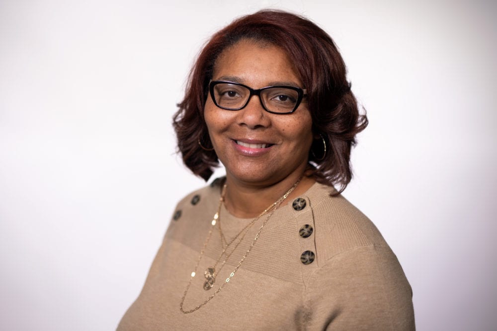 A headshot of Tonia Word—a black woman with short brown hair, wearing a tan sweater.