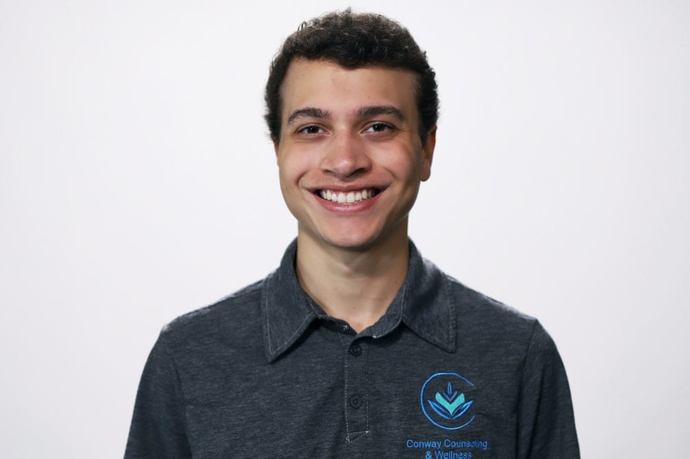 Headshot of Trey Kellybrew—a white man with dark brown hair, wearing a Conway Counseling & Wellness polo.